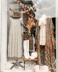 a window display with clothes and shoes in it