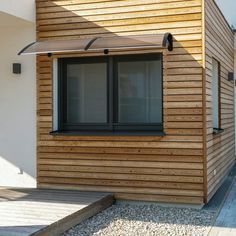 a house with wooden siding and black windows