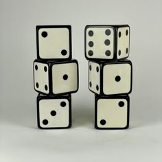 four black and white dices stacked on top of each other