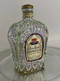 a bottle that is sitting on top of a glass plate with some beads around it