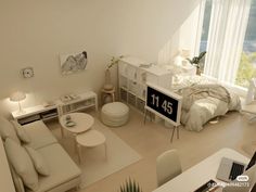 an aerial view of a living room and bedroom with white furniture on the floor,