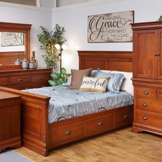 a bed room with a neatly made bed and wooden dressers next to each other