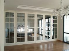 an empty room with glass doors and chandelier