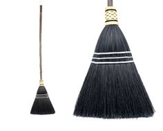 two brooms side by side with one black and the other white, on a white background