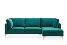 a green velvet couch with gold legs