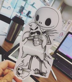 a person holding up a sticker with a skeleton on it