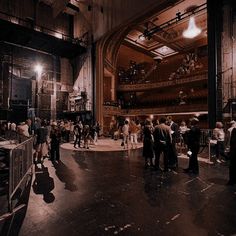 a large group of people standing in front of a stage