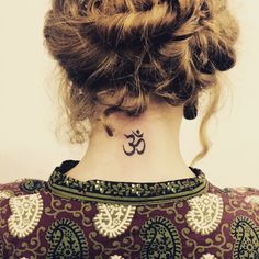 a woman with a small tattoo on her neck