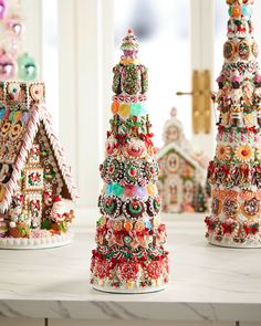 three christmas trees made out of candy canes on a table with windows in the background