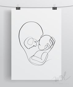 a black and white line drawing of a woman holding a baby in her arms, on a sheet of paper