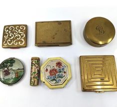 several different types of decorative items on a white surface with gold trimmings and designs