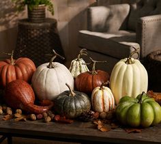 a group of pumpkins sitting on top of a wooden table