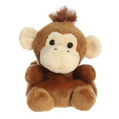 a small stuffed monkey sitting up against a white background