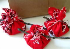 three red bags with white designs on them sitting on a table next to a brown box