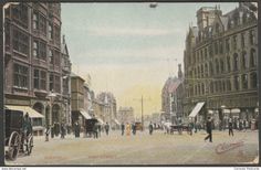 an old postcard shows people walking down the street in front of tall buildings and horse drawn carriages