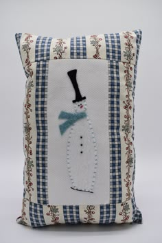 a pillow with a snowman on it