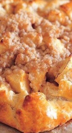 an apple pie with crumbs on top