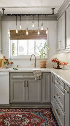 a kitchen with gray cabinets and white appliances