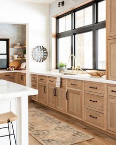 an instagram page on the iphone shows a kitchen with wooden cabinets and white counter tops