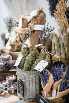 baskets filled with lavenders and herbs on top of a table next to other items