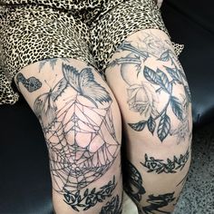 the legs of a woman with tattoos on them are covered in black and white ink