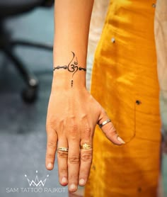 a woman's hand with a small tattoo on it