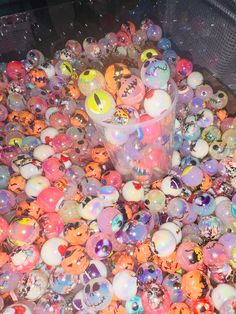 a bucket filled with lots of different colored balls