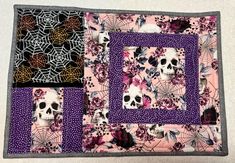 a purple and black quilt with skulls on it