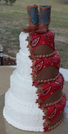 a three tiered cake with cowboy boots on the top and red, white, and brown icing