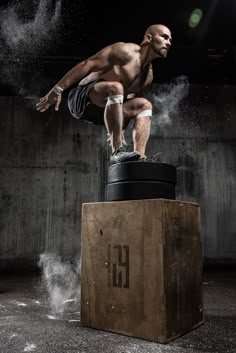 a man is doing a trick on top of a barrel