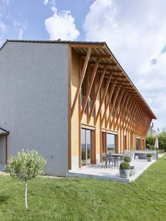 a house that is made out of wood and has an open roof on the side