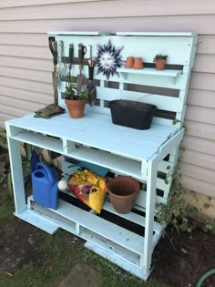 a potting bench made out of an old pallet with pots and plants on it