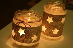 two mason jars with stars on them sitting on a table