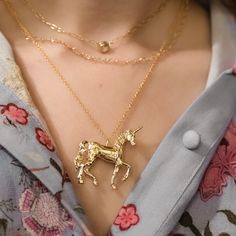 Title: Unicorn Pendant Necklace Material: 14k Gold Plate over Brass, gold fill chain.  Timeline:  Ships right away! Size: 40mmx42mm. Choose from 16, 18, or 20-inch 1mm cable chains. Special Options: Choose a chain from my shop to exchange for the cable chain. Message me for a special discount.  Story:  The stories and mythologies of unicorns are countless. This classic unicorn gently lifts its hoof and turns its head. The shining creature is engraved with stars.   Packaging: All items are nicely Unicorn Jewelry, Last Unicorn, Dainty Band, The Last Unicorn, Unicorn Pendant, Unicorn Necklace, Horse Jewelry, The Shining, Brass Gold