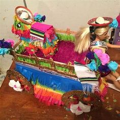 a doll sitting in a colorfully decorated carriage