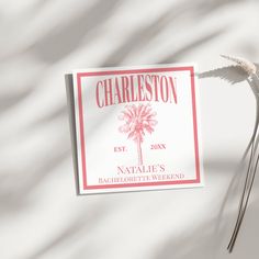 the label for charleston wine is displayed on a white tablecloth with a pink palm tree in the background