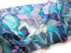 Hand painted scarf with Pegasus made of natural silk, in purple - blue - turquoise color set. This fantasy designer scarf is made to order. The Pegasus is a magical creature, a winged horse symbolizing wisdom and fame and more recently poets' inspiration (so imagine what a lovely gift the scarf would made for your poet friend). The Pegasus scarf depicts the winged horse flying with two peacocks on a starry, cloudy night sky. It is composed with tones of cool blue and turquoise, soft pastel mint Blue Hand Painted Bohemian Silk Scarf, Blue Bohemian Hand Painted Silk Scarf, Bohemian Blue Silk Scarf Gift, Bohemian Blue Hand Painted Silk Scarf, Bohemian Blue Silk Scarf As Gift, Bohemian Blue Silk Scarf For Gift, Artistic Handmade Blue Silk Scarf, Hand Painted Blue Silk Scarf For Gift, Artsy Blue Scarf As A Gift