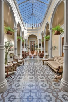 the inside of a large building with many chairs and couches on it's sides