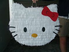 a hello kitty pinata being held by someone