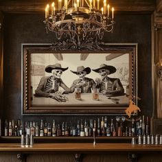 two skeletons sitting at a bar with beer glasses in front of them and a painting on the wall