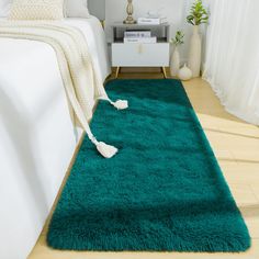 a green rug on the floor in a bedroom