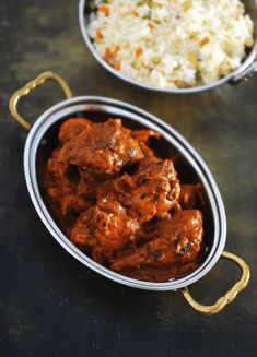 two bowls filled with meat and rice on top of a black table next to each other