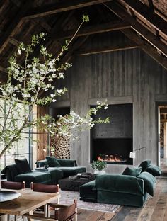 a living room filled with furniture and a fire place in the middle of a room