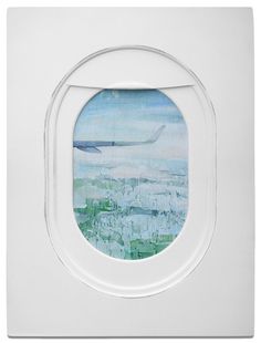 an airplane window with a painting on it