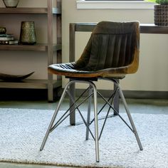 a chair sitting on top of a rug in front of a book shelf filled with books