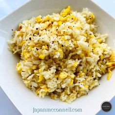 a white bowl filled with rice and other food