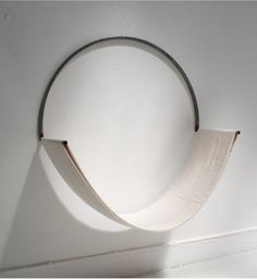 a circular object hanging on the wall with a white cloth covering it's back