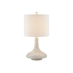 a white table lamp with a beige shade on the base and a light bulb in front of it