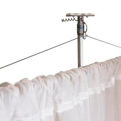 a white curtain is hanging on a clothes line