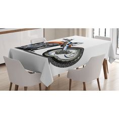 a dining table with white chairs and an image of a bike on it